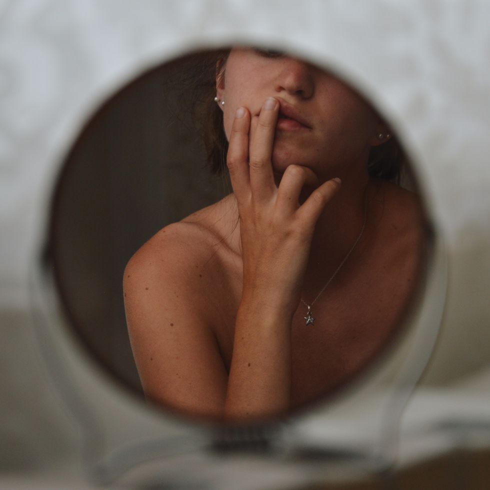 portrait of a woman on circular mirror