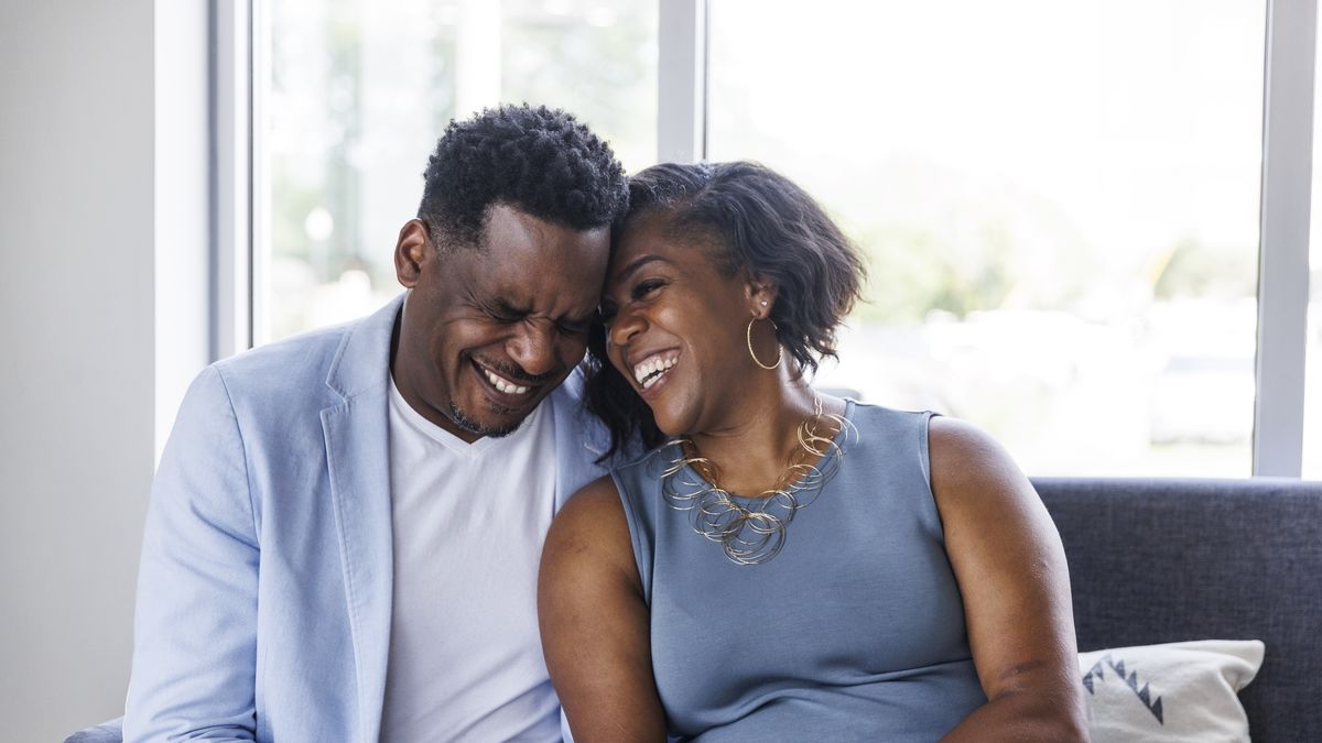 portrait of affectionate mature couple sitting on sofa