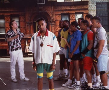 spike lee at center with danny aiello on one side and a crowd of young men to the other in a still from do the right thing