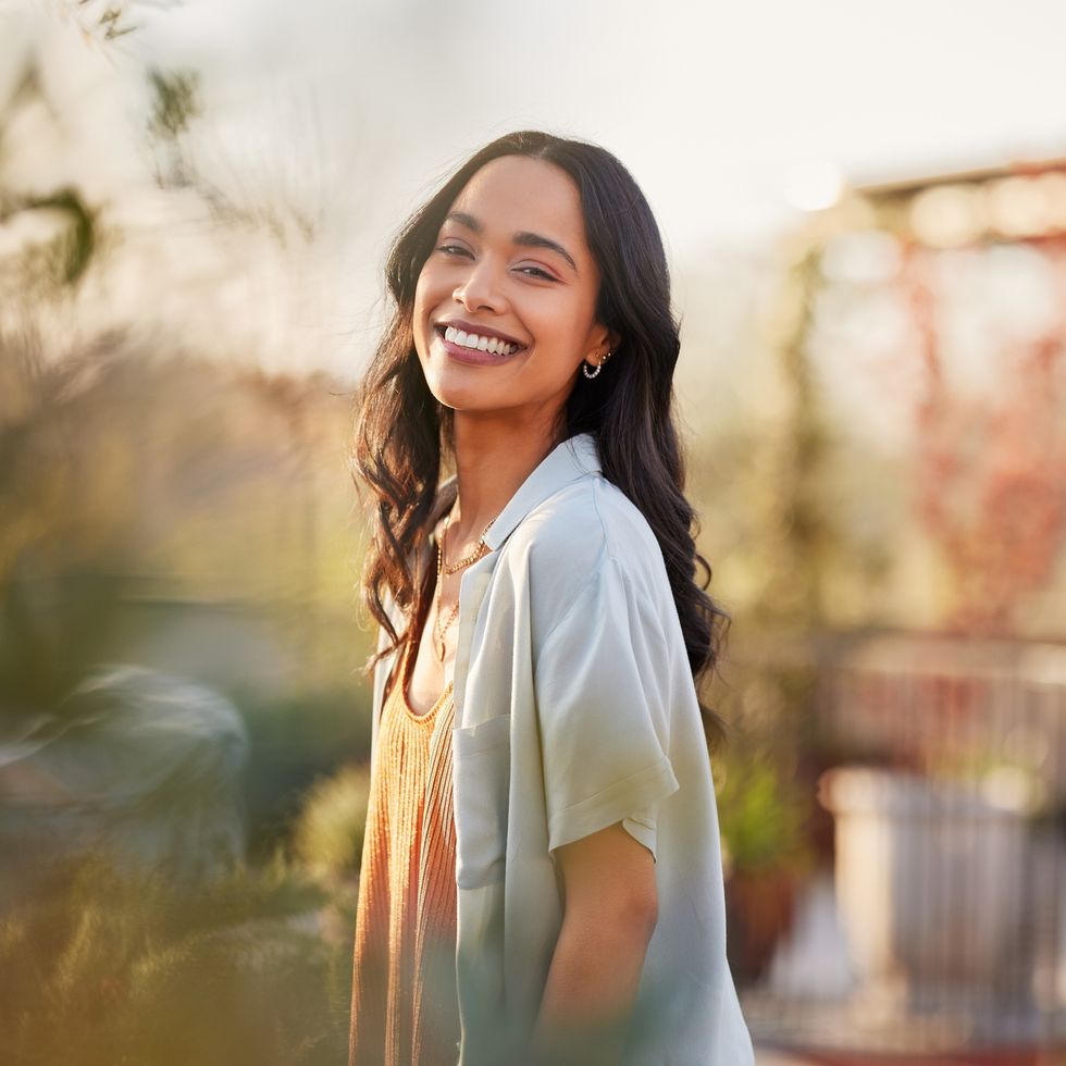 portrait of beautiful happy woman smiling during sunset outdoor