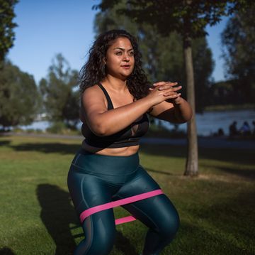 functional fitness  portrait of beautiful young overweight woman outdoors on riverbank in city,  doing exercise