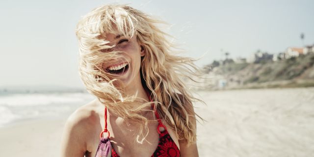 Portrait of cheerful woman on beach