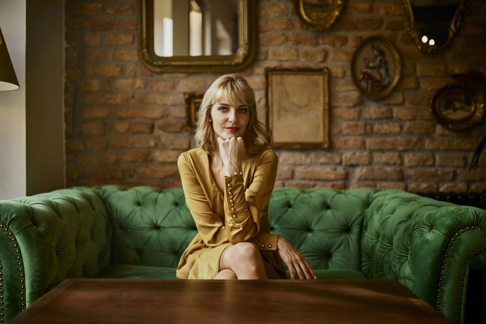 portrait of elegant woman sitting on a couch