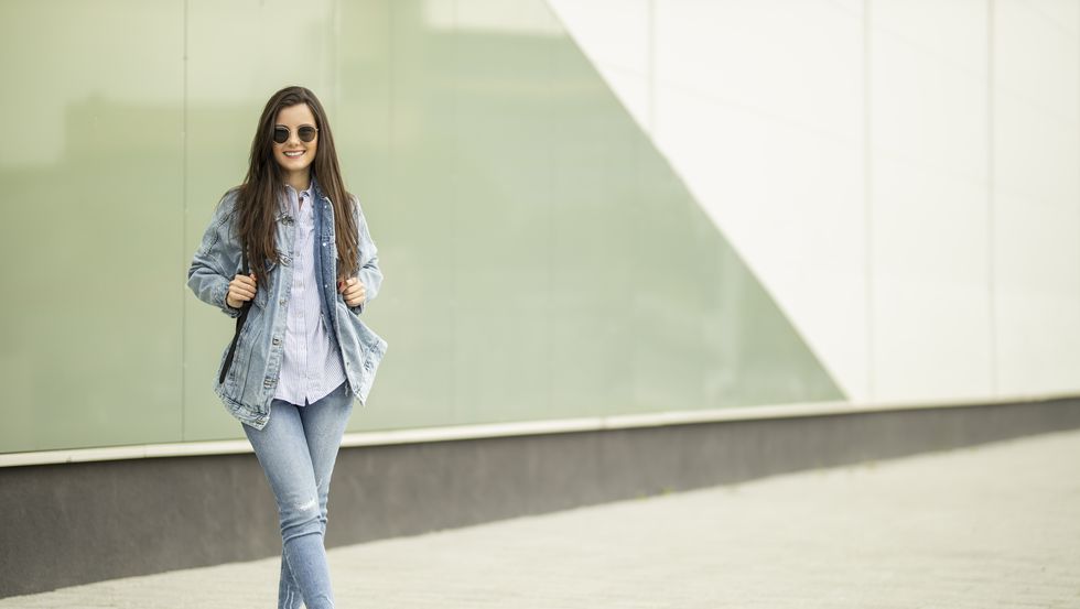 girl smiling with a backpack and shirt