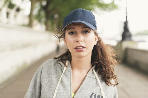 Portrait of female runner wearing baseball cap