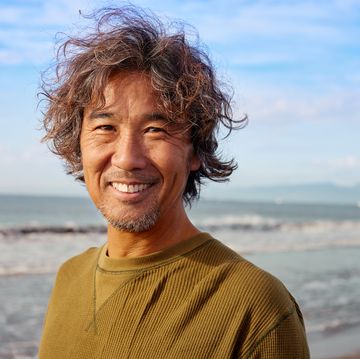 portrait of genuine surfer man in 50s with smile