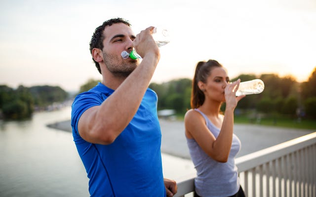 portrait of happy fit sporty couple relaxing after a running outdoors