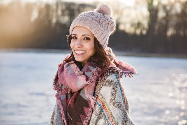 Portrait of happy woman outdoors in winter