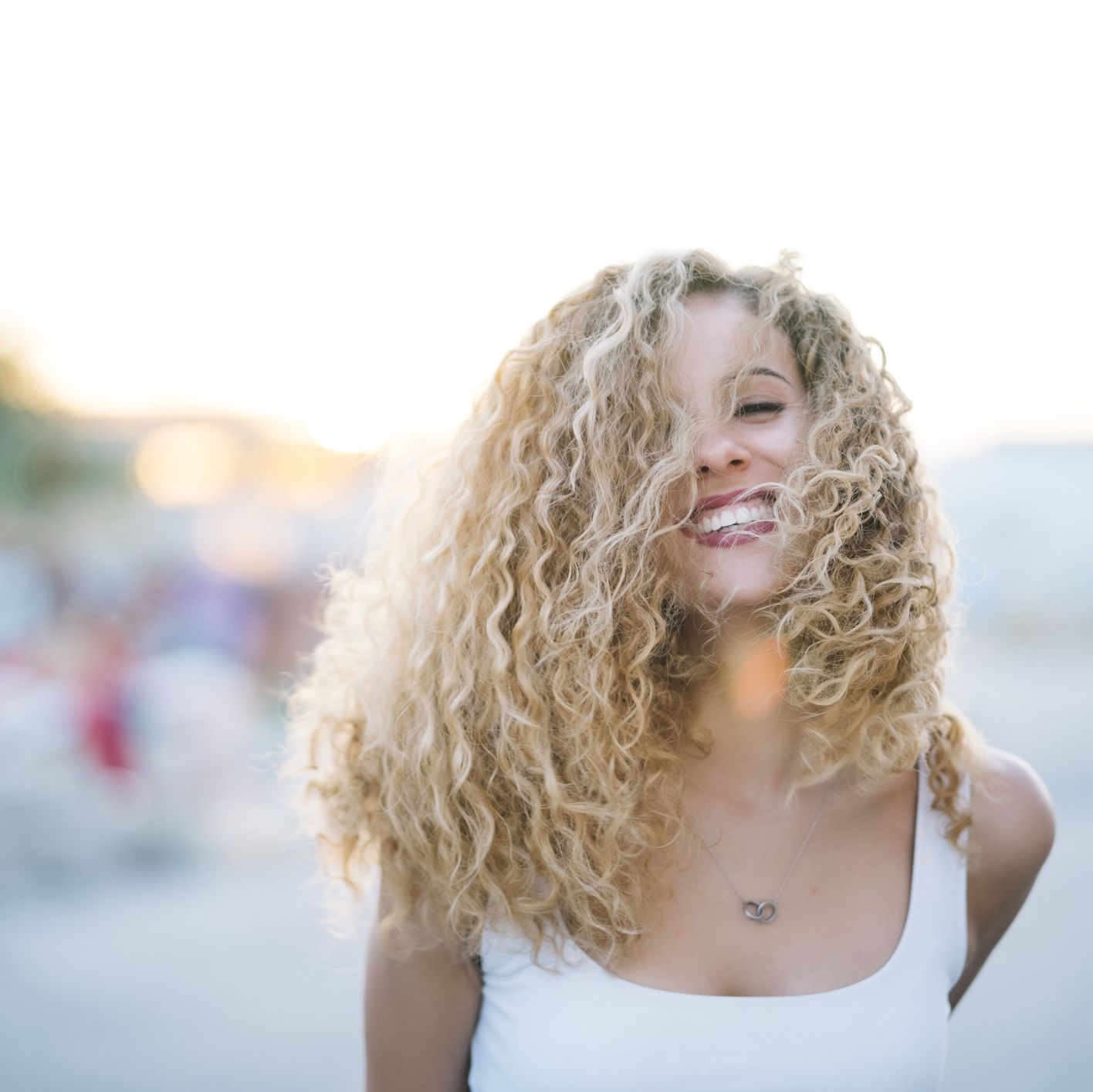portrait of happy young woman with blond ringlets