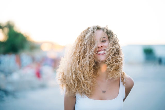 portrait of happy young woman with blond ringlets