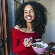 reverse dieting portrait of laughing young woman eating cereals