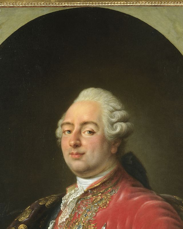 portrait of louis xvi wearing a bright red jacket adorned with a blue sash and medals