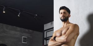 portrait of muscular macho man shirtless crossed arms