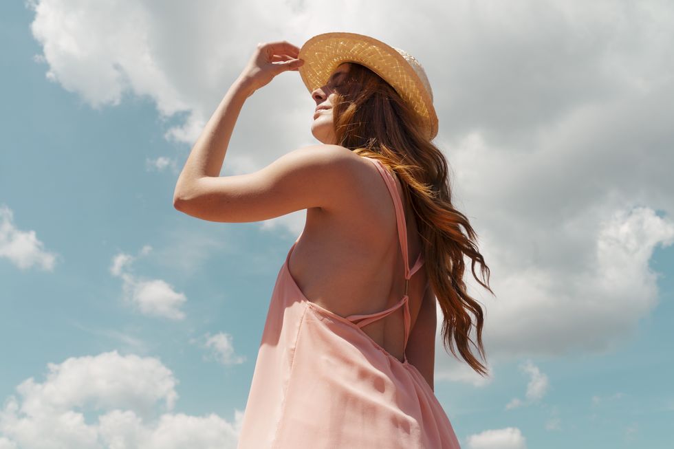 portrait of redheaded woman enjoying sunlight