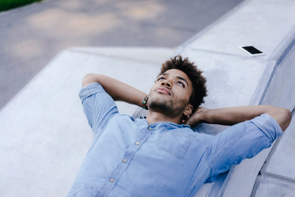 relaxed man lying in park