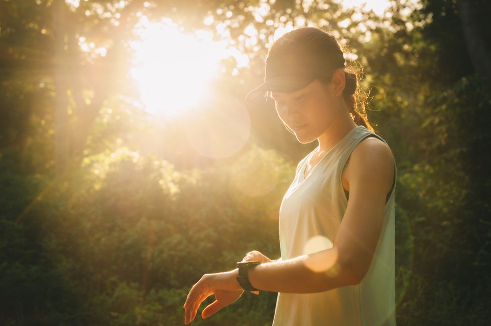 portrait of runner woman checking fitness progress on her smart watch