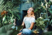 portrait of smiling fair haired woman, sitting and doing breathwork
