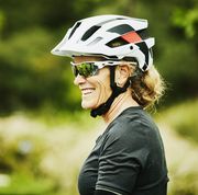 portrait of smiling mature woman relaxing after mountain bike ride with friends