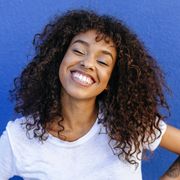 Portrait of smiling woman with blue background