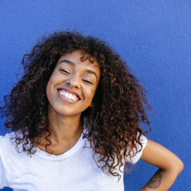 https://hips.hearstapps.com/hmg-prod/images/portrait-of-smiling-woman-with-blue-background-royalty-free-image-1568306086.jpg?crop=0.668xw:1.00xh;0.112xw,0&resize=640:*