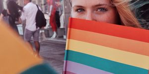 Portrait Of Teenage Girl Holding Rainbow Flag