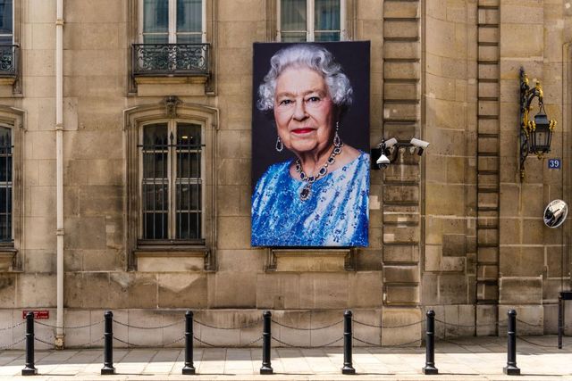 portraits of her majesty the queen are displayed in front of the british ambassadors residence to celebrate queens jubilee