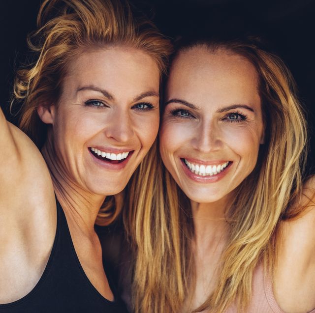 portrait of two smiling blond women