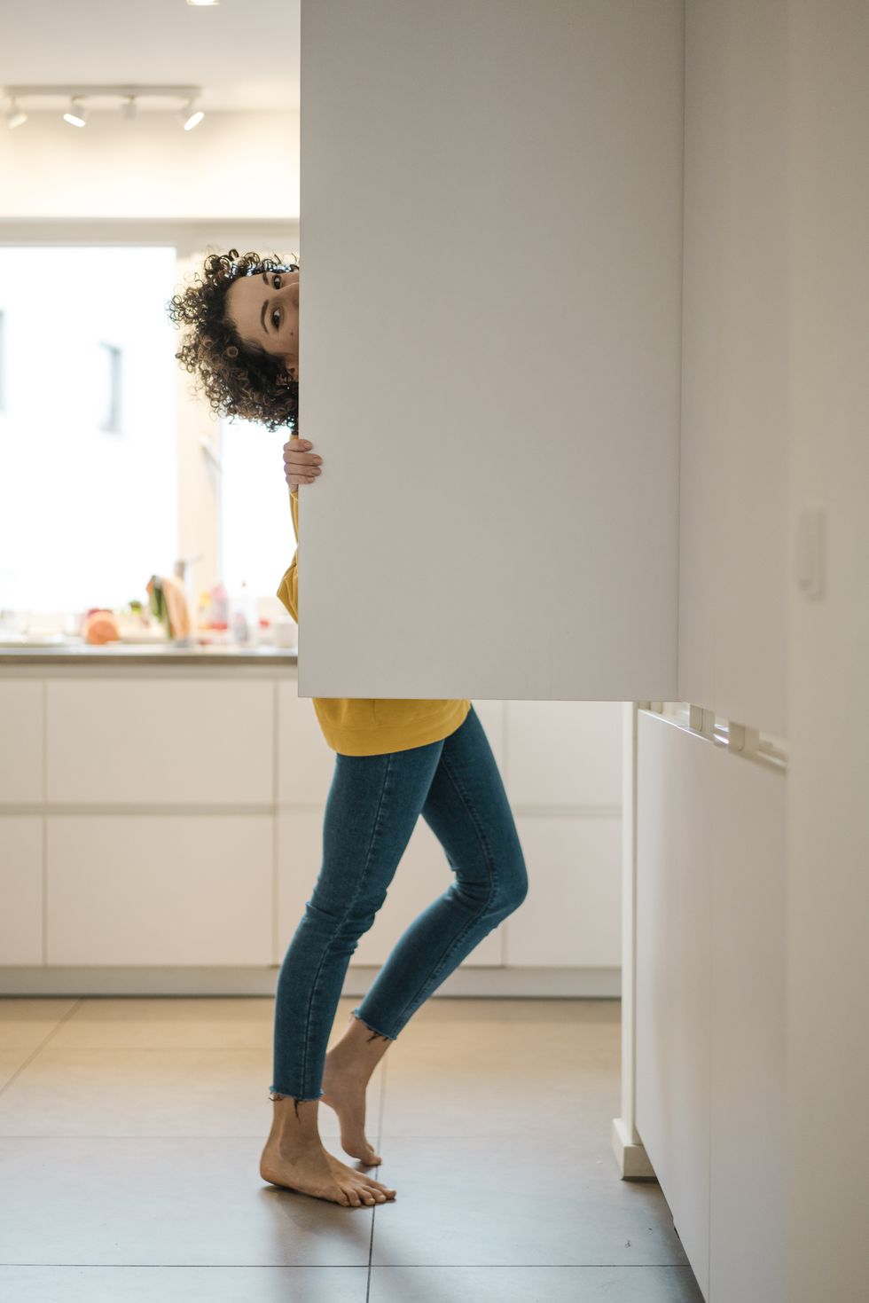 portrait of woman at the fridge in kitchen at home