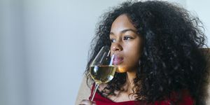 portrait of woman drinking glass of white wine