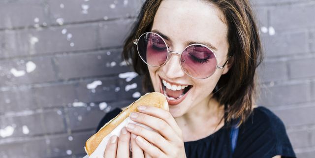 Portrait of woman eating a Hot Dog