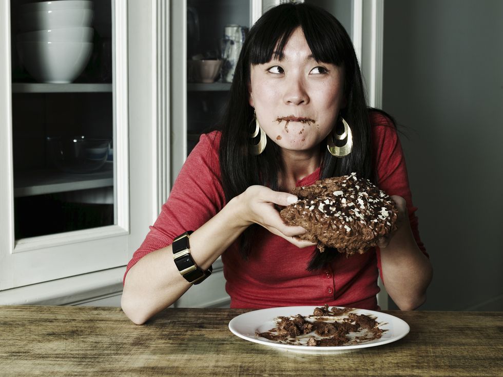Portrait of woman eating chocolate cake