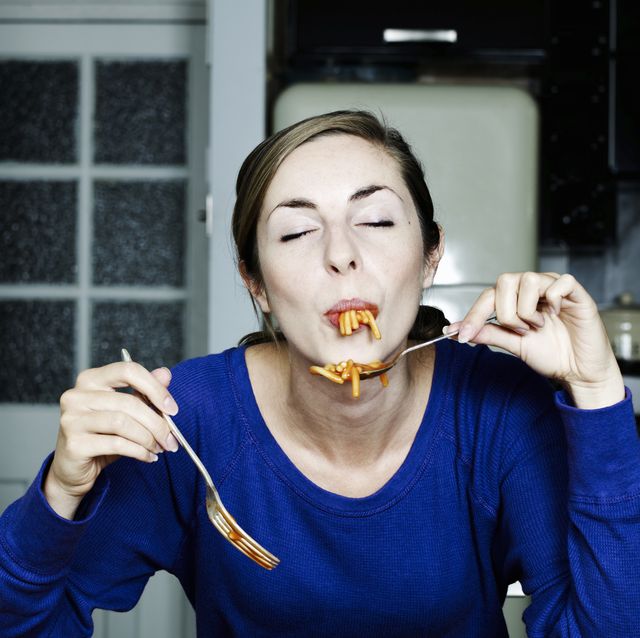 portrait of woman eating spaghetti