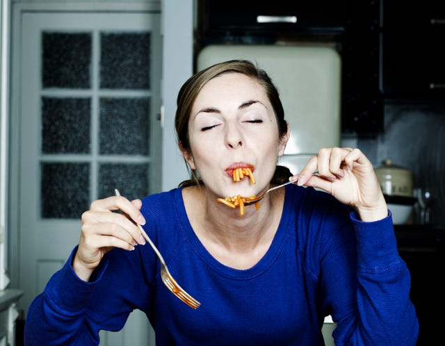 portrait of woman eating spaghetti