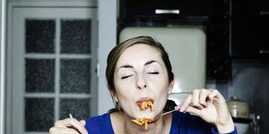 portrait of woman eating spaghetti