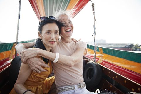 portrait of woman sitting with friend in boat