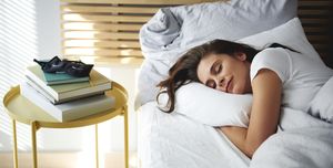 portrait of woman sleeping in bed by daylight