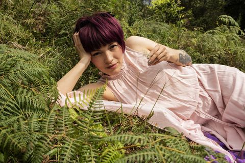 Portrait of  woman with purple hair in nature