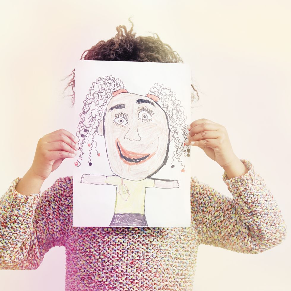 portrait of young girl, holding drawing, covering face fun activities for kids