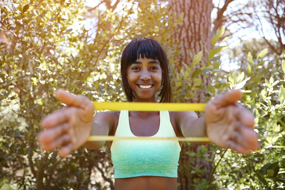 Young Woman Doing Chest Exercise In Fitness Center-102027