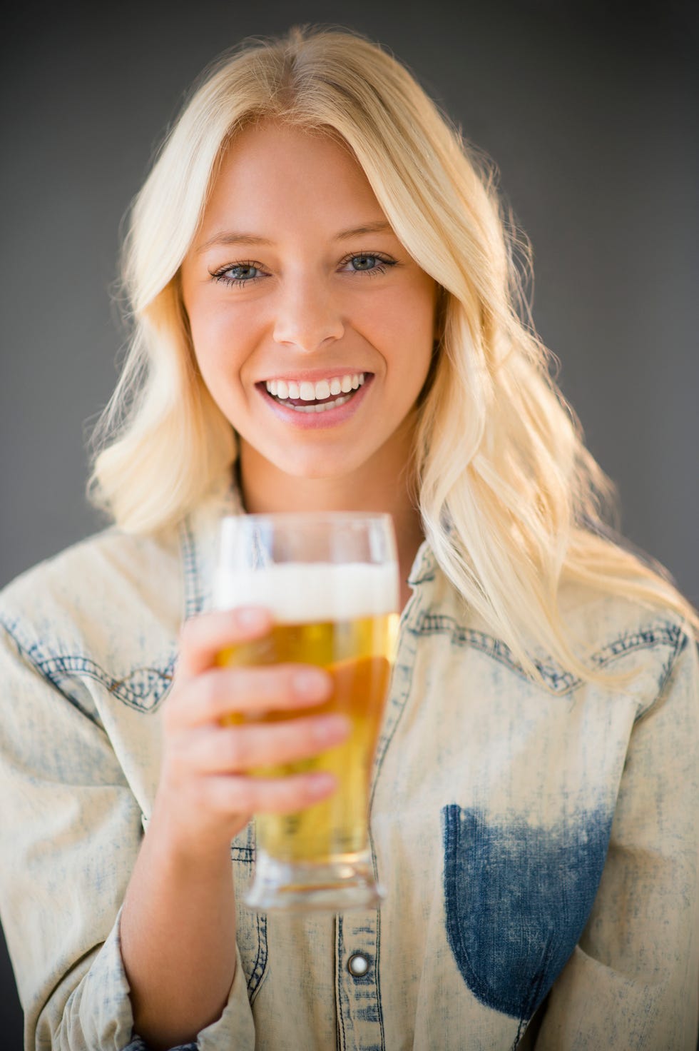 virtual happy hour ideas -  Portrait of young woman holding glass of beer, Jersey City, New Jersey, USA