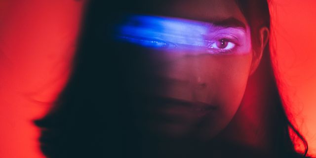 https://hips.hearstapps.com/hmg-prod/images/portrait-of-young-woman-lit-by-blue-and-red-neon-royalty-free-image-1734546568.pjpeg?crop=1xw:0.75035xh;center,top&resize=640:*