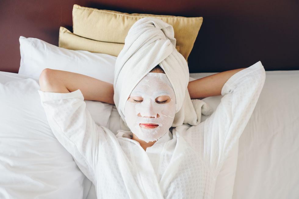 portrait of young woman sleeping on bed with applying facial mask for enhance her skin