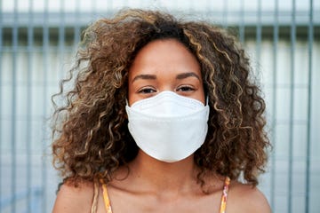 portrait of young woman with antiviral mask outdoors