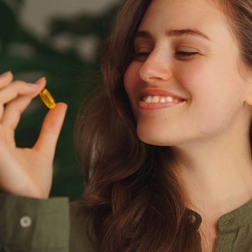 portrait of young woman with pill