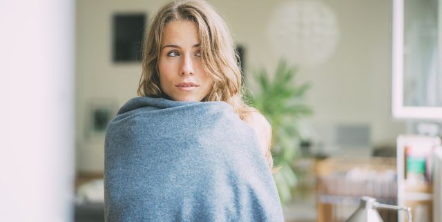 Portrait of young woman wrapped in a blanket