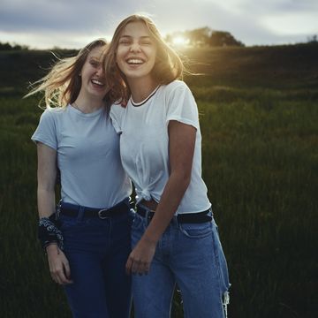 Portrait smiling, happy teenage sisters in rural field