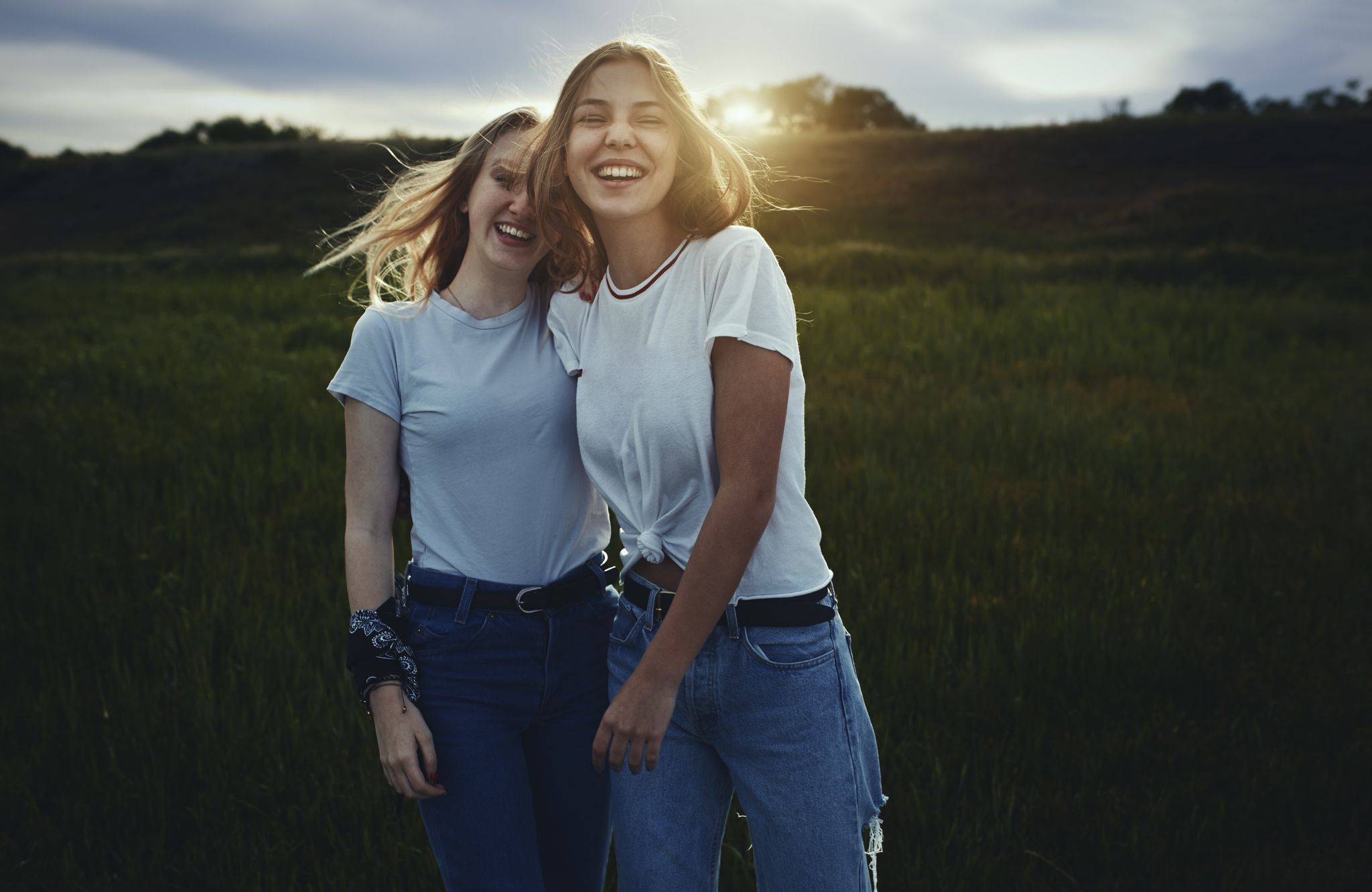 Portrait smiling, happy teenage sisters in rural field