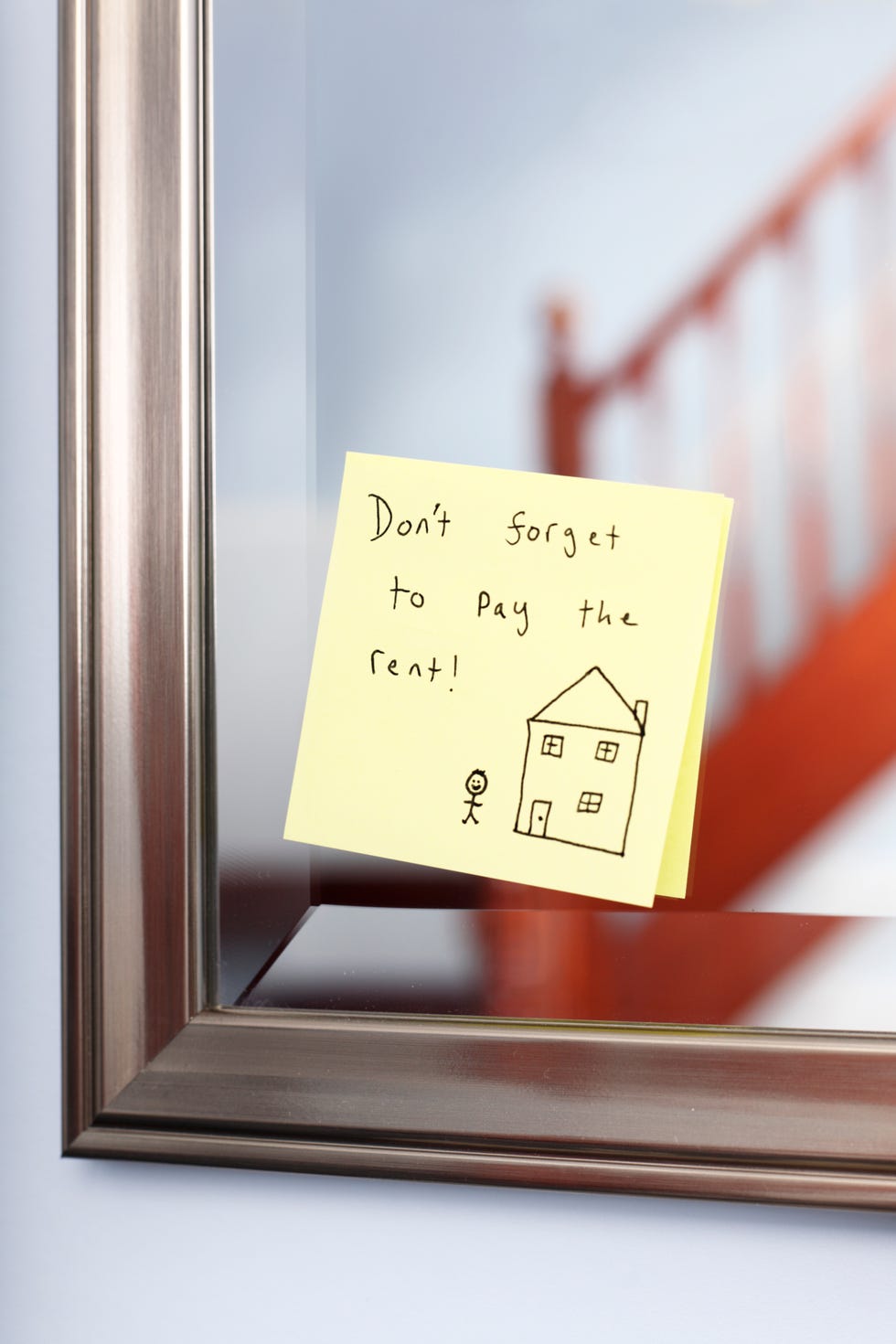 post it note with rent reminder on mirror