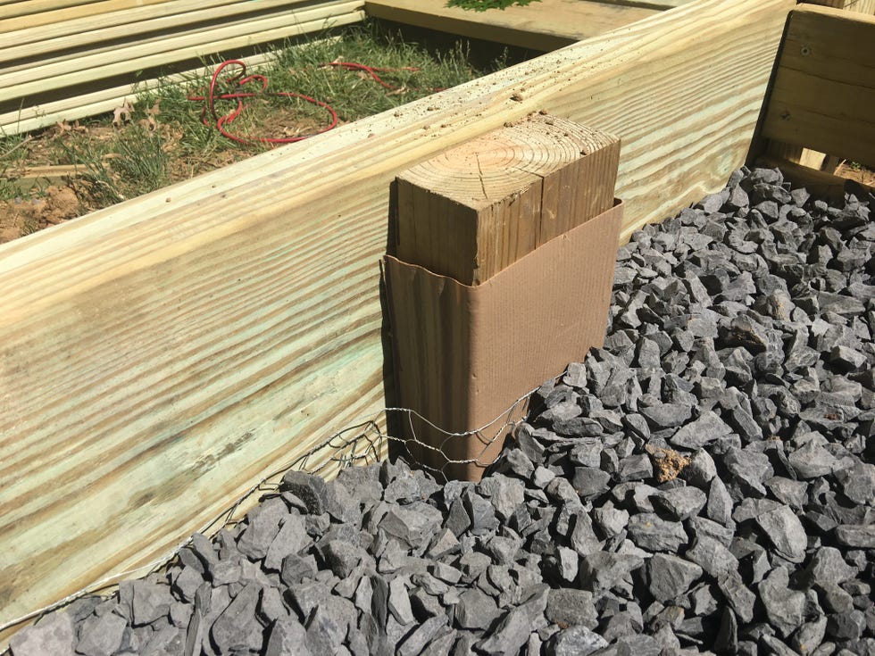 a wooden box on a gravel surface