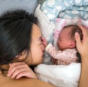 newborn baby and mom snuggling